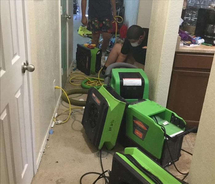 Restoration equipment cleaning up water damage in a home