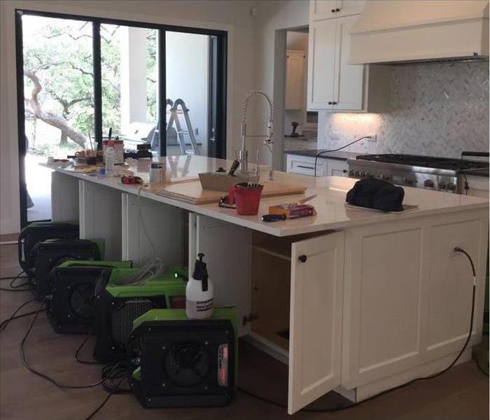 Air movers (fans) placed in a kitchen